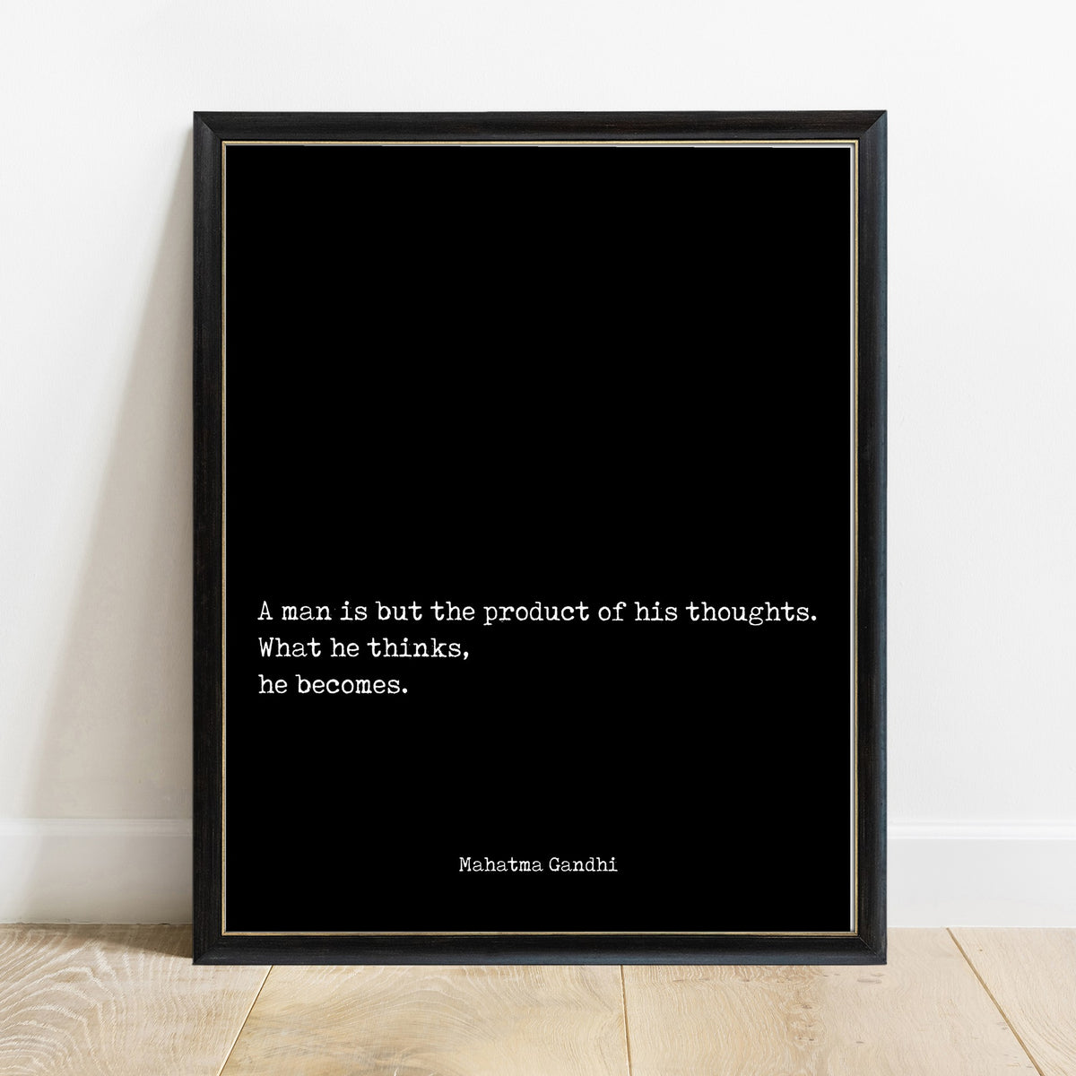 Mahatma Gandhi a man is but the product of his thoughts quote print in a black frame, black background