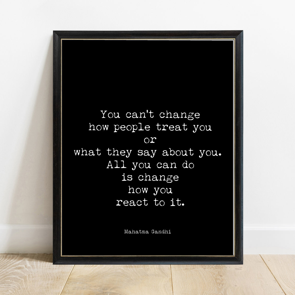 Gandhi you can't change how people treat you quote print in a black frame, black background