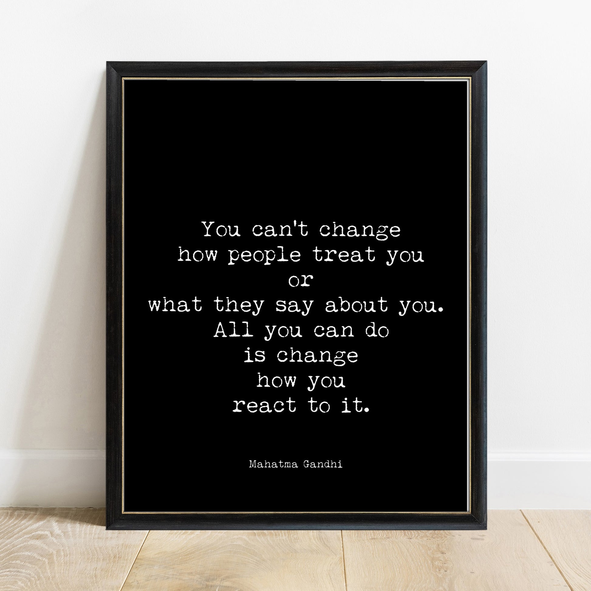 Gandhi you can't change how people treat you quote print in a black frame, black background