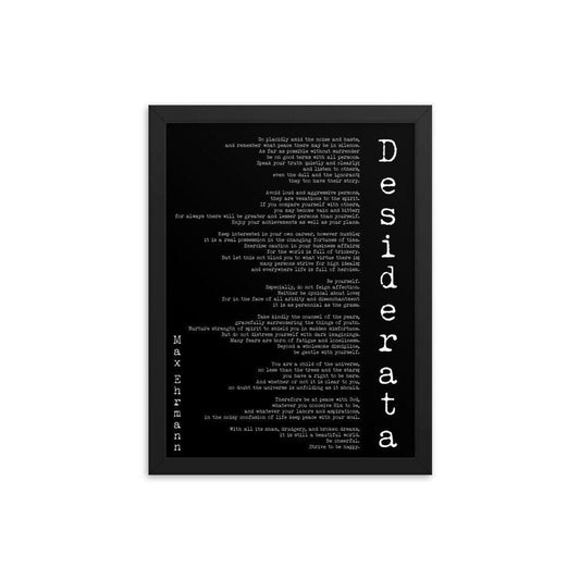 May include: A black and white framed print with the text 'Desiderata' in large white letters. The text is a poem by Max Ehrmann. The poem is printed in a typewriter font and is centered on the page. The background of the print is black.