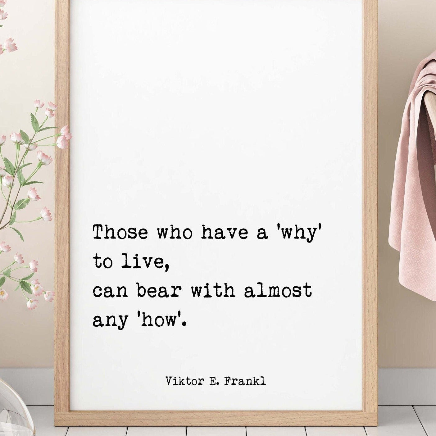May include: A framed print with a white background and black text. The text reads 'Those who have a 'why' to live, can bear with almost any 'how'.' The text is attributed to Viktor E. Frankl.