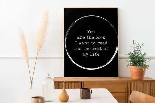May include: A black and white poster with a white circle and the text 'You are the book I want to read for the rest of my life'.