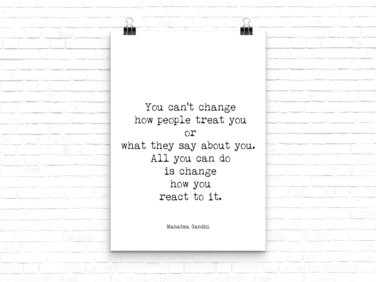May include: A black and white typography poster with the quote 'You can't change how people treat you or what they say about you. All you can do is change how you react to it.'  The quote is attributed to Mahatma Gandhi.