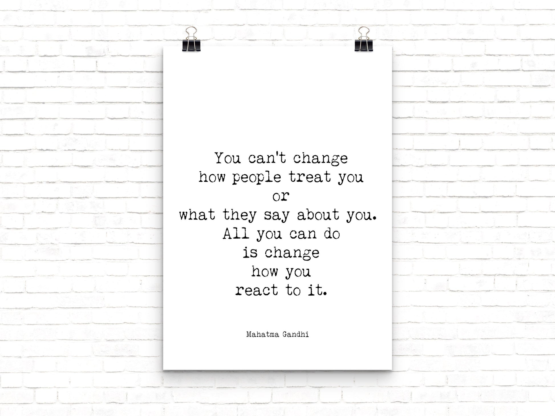 May include: A black and white typography poster with the quote 'You can't change how people treat you or what they say about you. All you can do is change how you react to it.'  The quote is attributed to Mahatma Gandhi.
