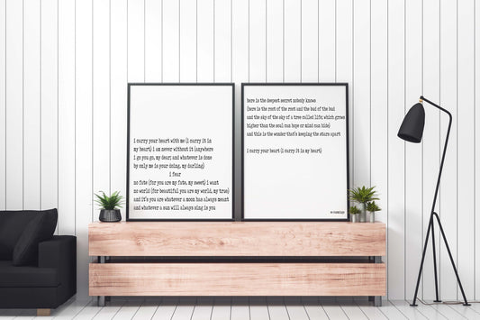 May include: Two black framed prints with white text on a white background. The text is a poem by E.E. Cummings. The prints are hanging on a light wood wall shelf above a dark brown sofa.
