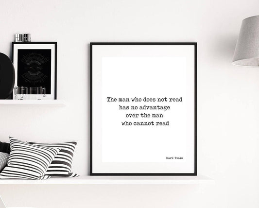 May include: A black and white typography print with the quote 'The man who does not read has no advantage over the man who cannot read' by Mark Twain. The print is framed in a black frame and is hanging on a white wall.