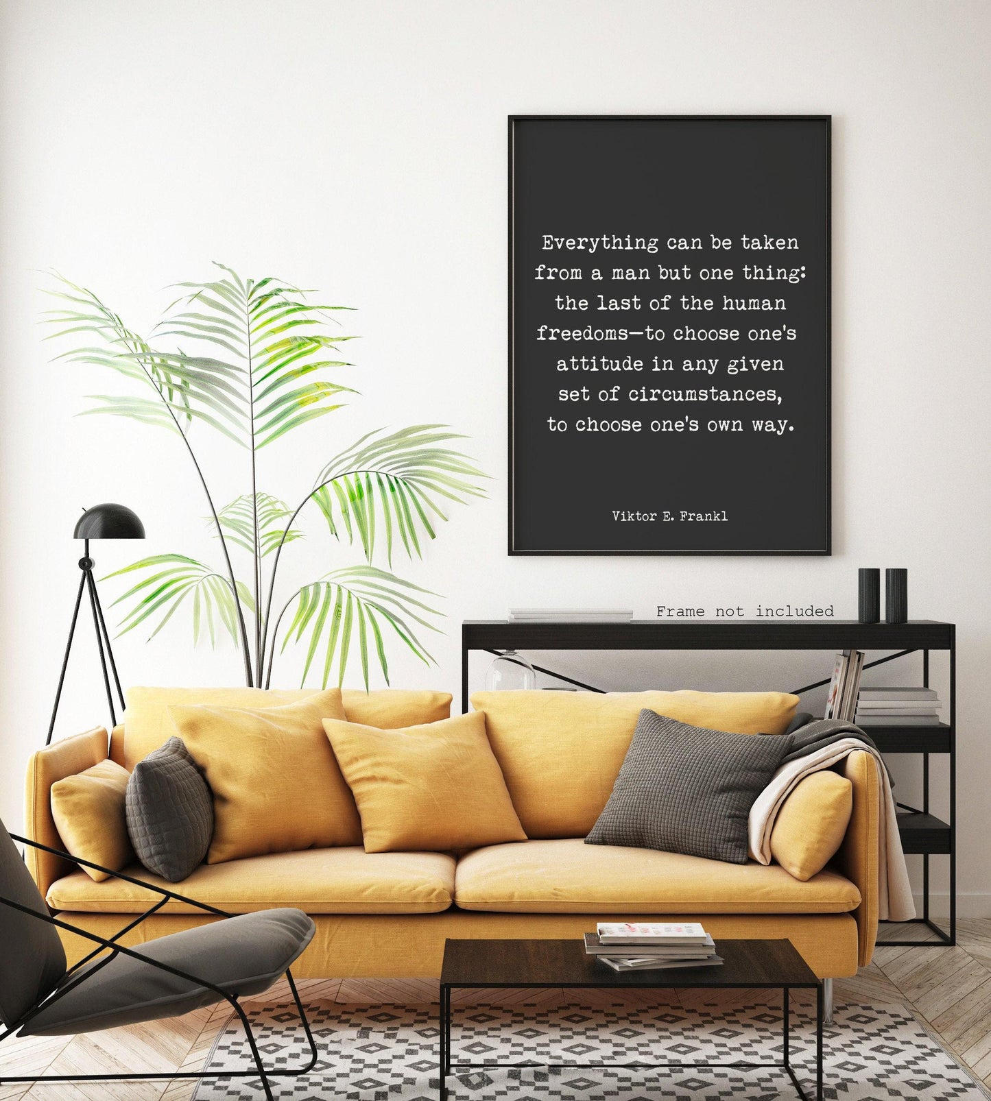 A black print with white text, "Everything can be taken from a man but one thing: the last of the human freedoms—to choose one's attitude in any given set of circumstances, to choose one's own way. Viktor E. Frankl," hangs on a white wall above a