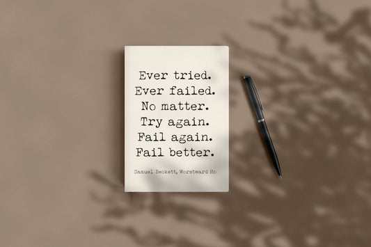 Samuel Beckett Ever tried. Ever failed. Fail better journal lying flat beside a black pen