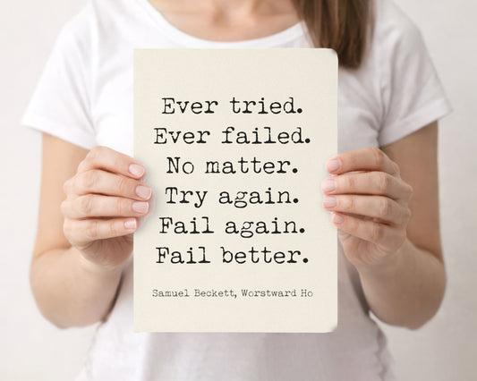 Woman holding a cream softcover journal with the Samuel Beckett Ever tried. Ever failed. Fail better quote on the front