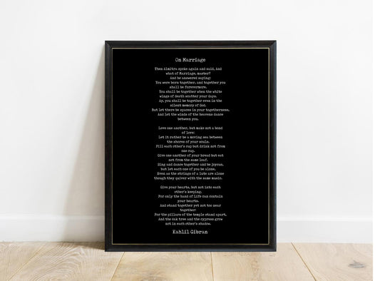 Kahlil Gibran On Marriage poem print in a black frame, black background