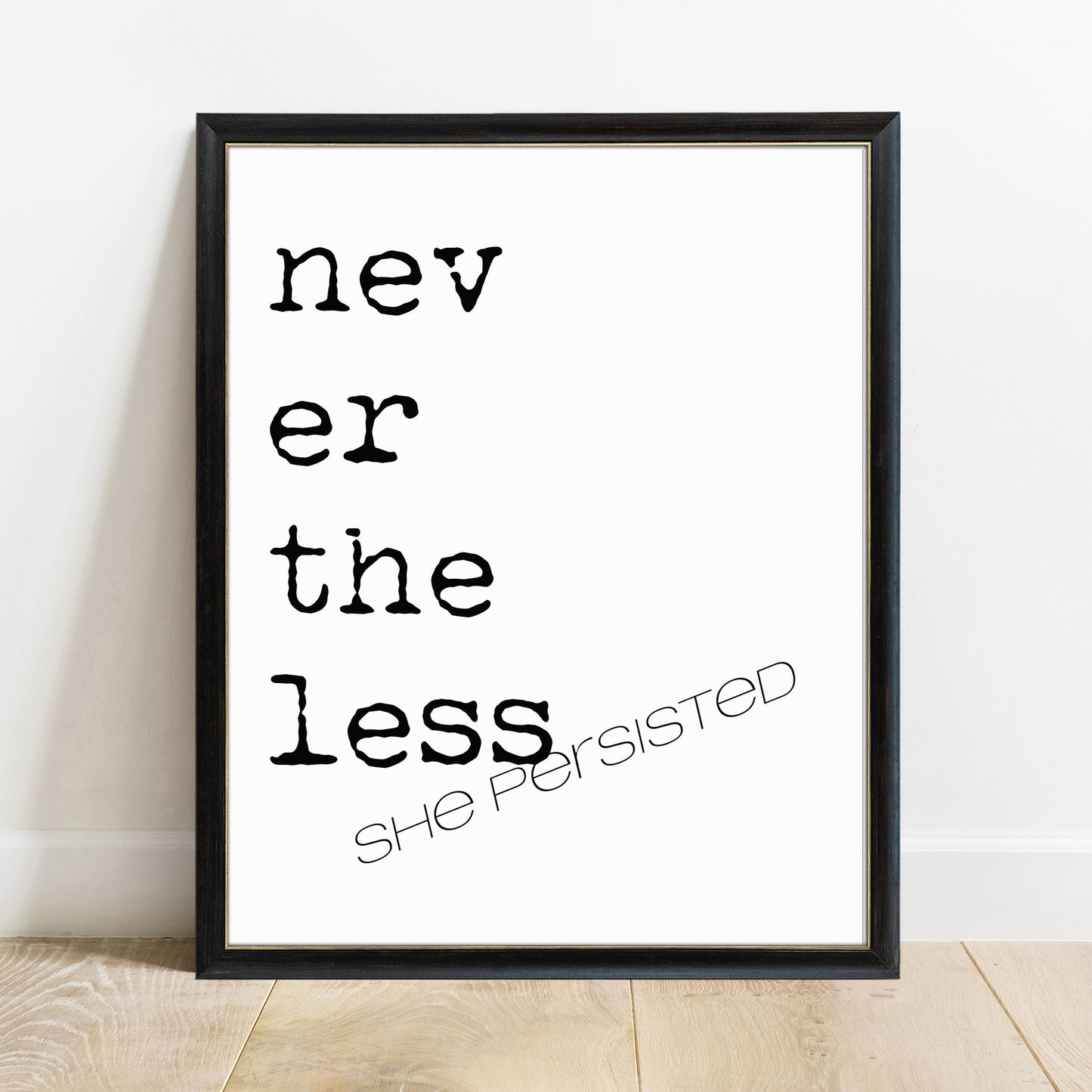 Nevertheless she persisted quote print in a black frame, white background