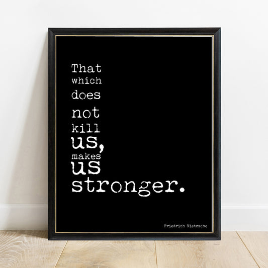 Friedrich Nietzsche that which does not kill us makes us stronger stacked bold typewriter print in a black frame, black background