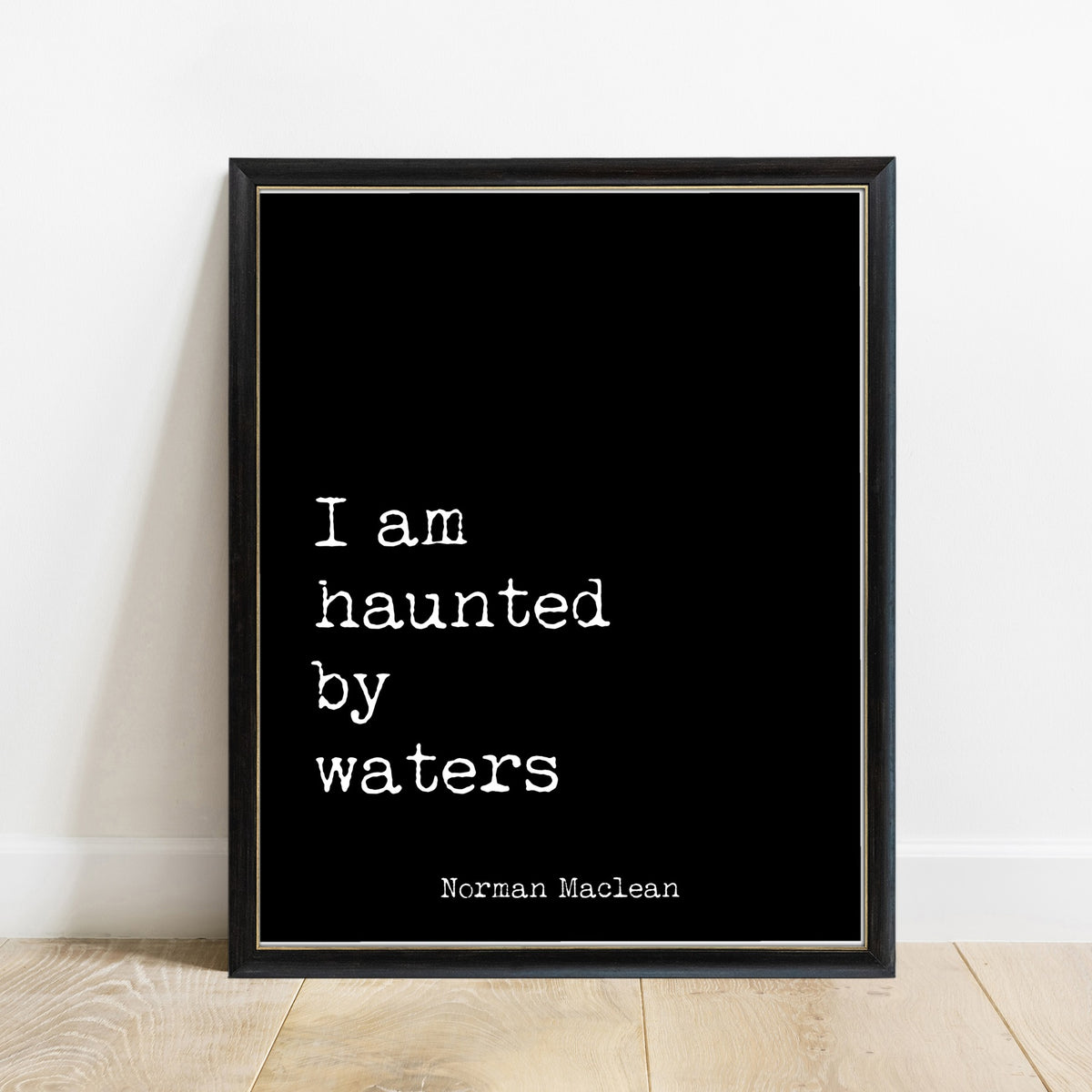 Norman Maclean I Am Haunted By Waters print in a black frame, black background