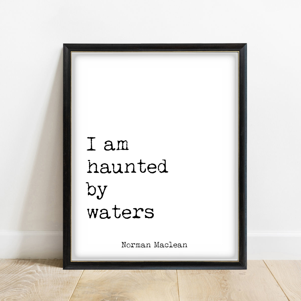Norman Maclean I Am Haunted By Waters print in a black frame, white background