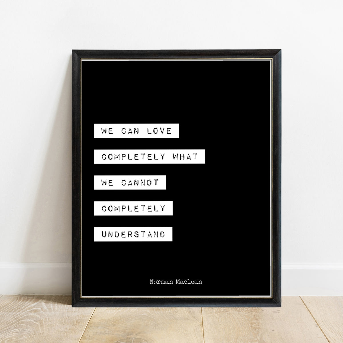 Norman Maclean We Can Love Completely print in a black frame, black background