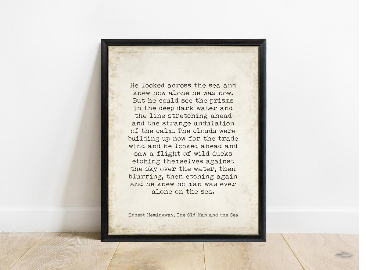 Ernest Hemingway The Old Man and the Sea no man was ever alone on the sea quote print in a black frame, vintage background