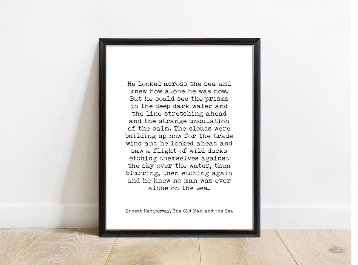 Ernest Hemingway The Old Man and the Sea no man was ever alone on the sea quote print in a black frame, white background