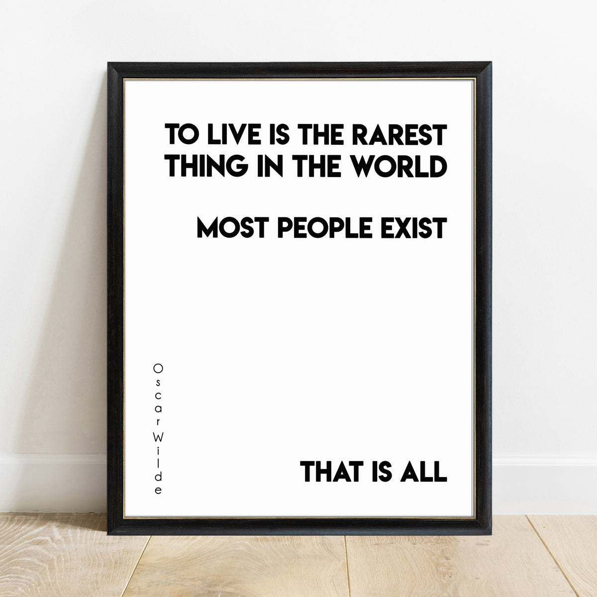 Oscar Wilde to live is the rarest thing quote print in a black frame, white background