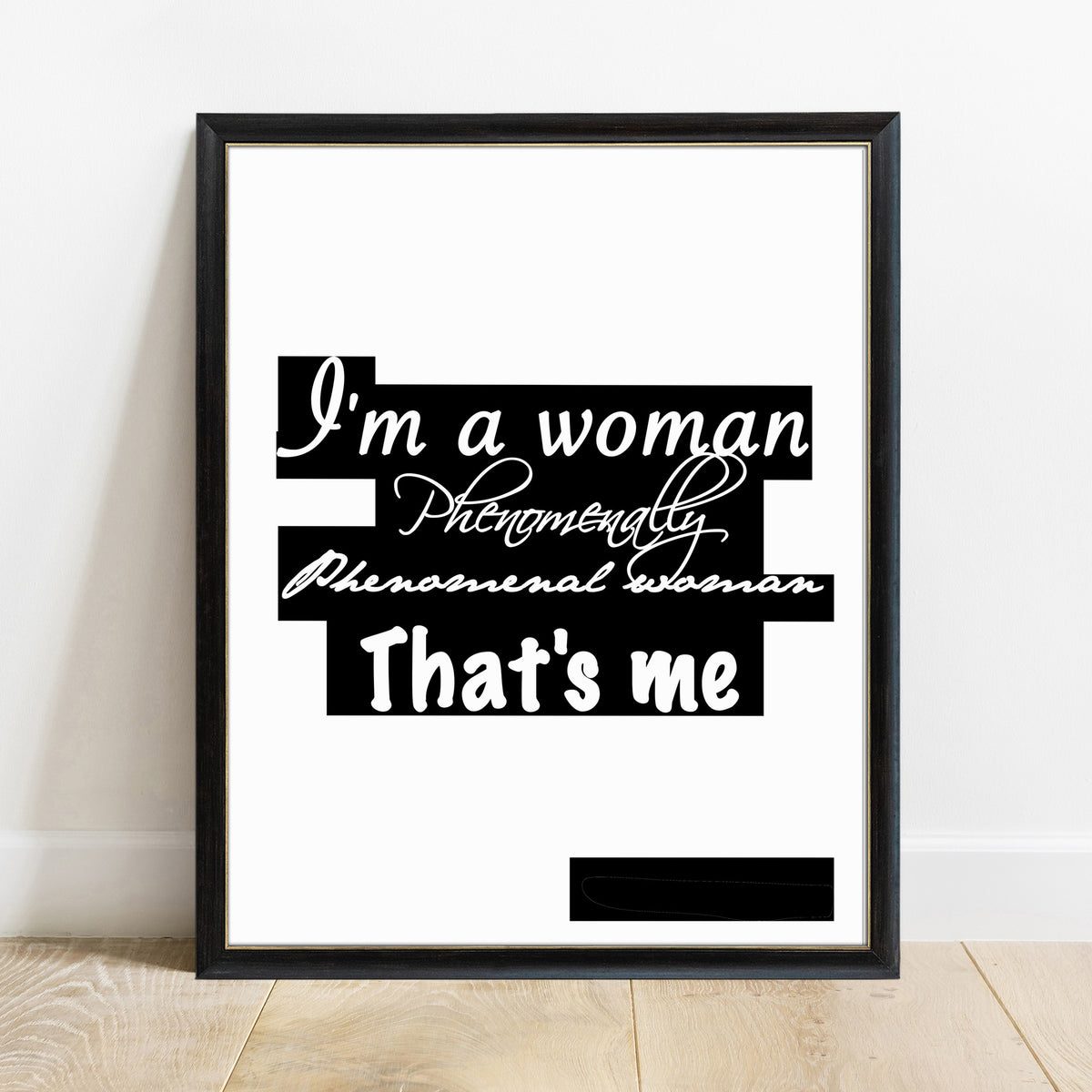 Maya Angelou I'm a woman phenomenally script print in a black frame, black background