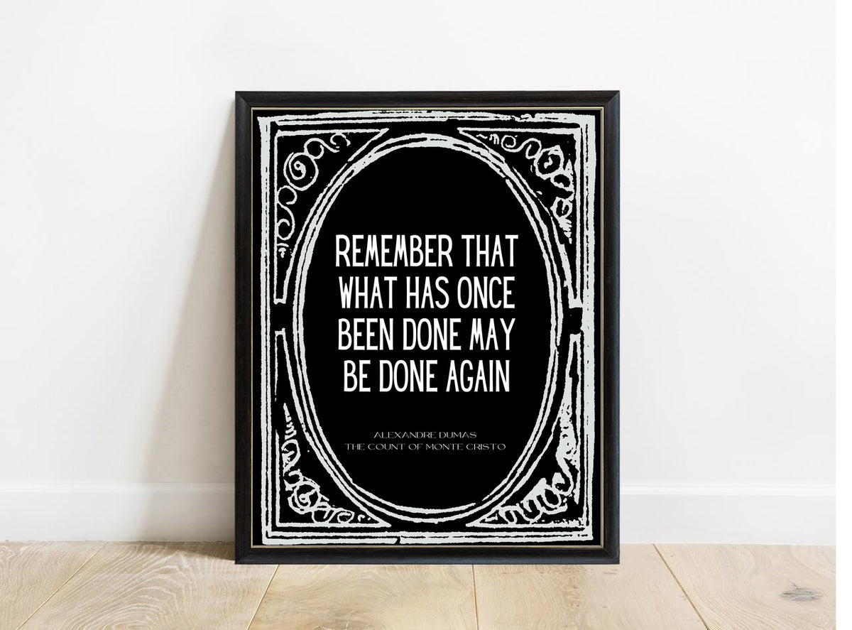 Alexandre Dumas Remember That What Has Once Been Done quote print in a black frame, black background