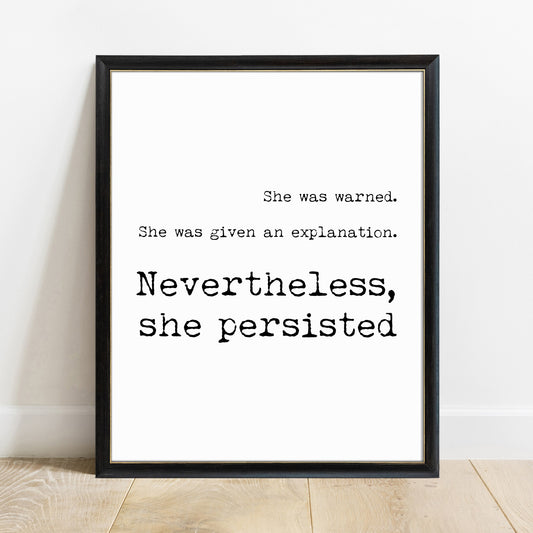 Nevertheless, she persisted feminist typewriter quote print in a black frame, white background