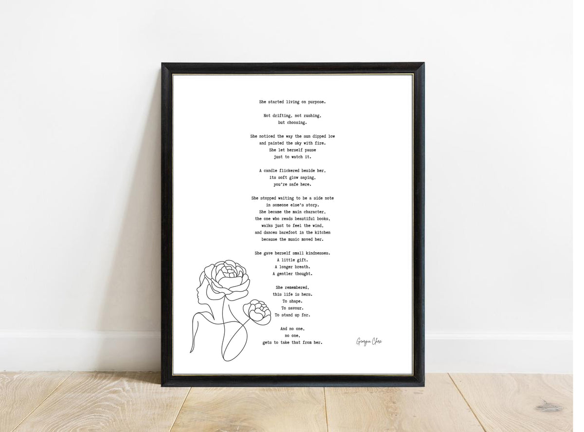 Georgia Clare She Started Living on Purpose poem print in a black frame, white background