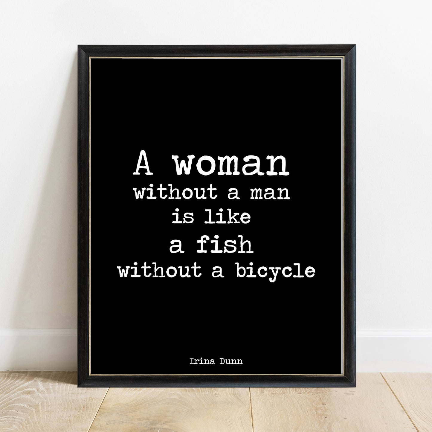 A woman without a man is like a fish without a bicycle print in a black frame, black background